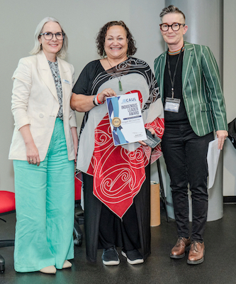 Abigail McClutchie (center) from the University of Auckland receives the CAUL Indigenous Leader Award - Aotearoa from CAUL CEO Jane Angel (left) and CAUL Board Chair Nicole Clark (right)