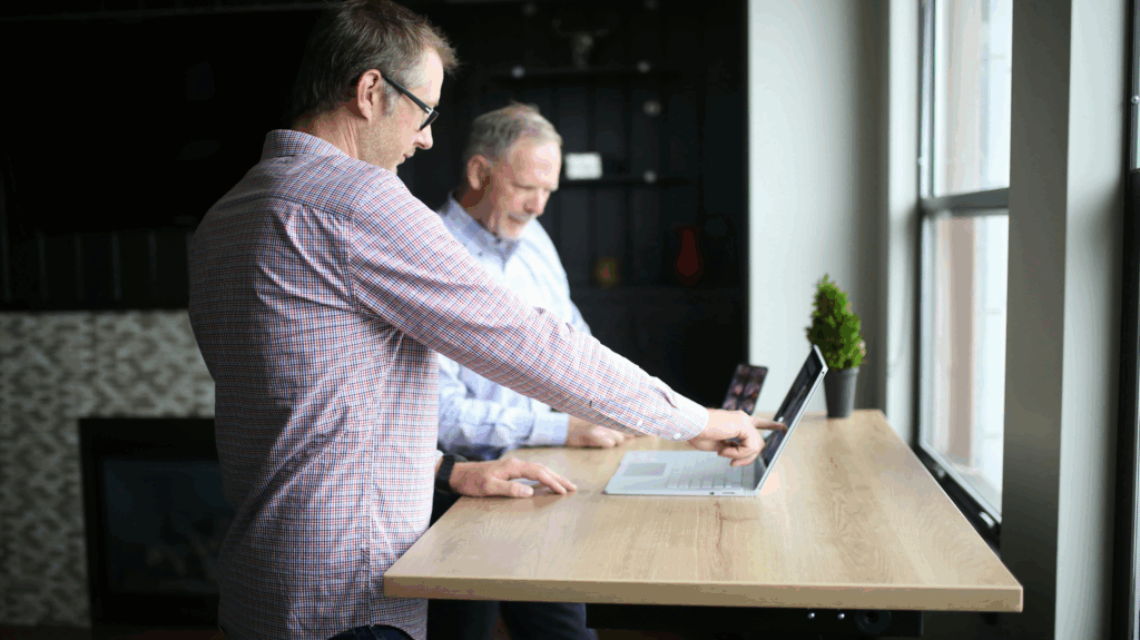 two men looking at a computer screen